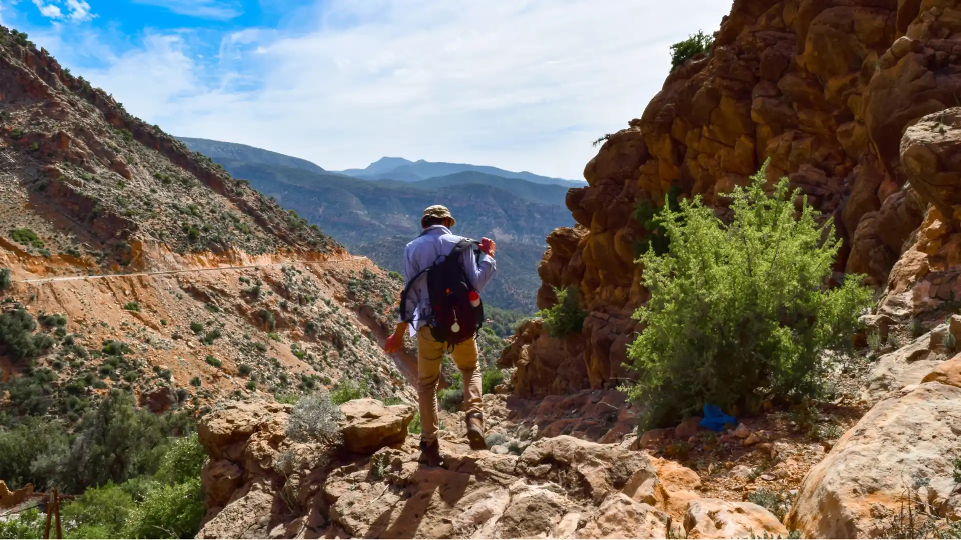 Atlas Mountains Tours Morocco - Hiking, Treks & Berber Villages ; Hikers looking out over a green valley in the Atlas Mountains