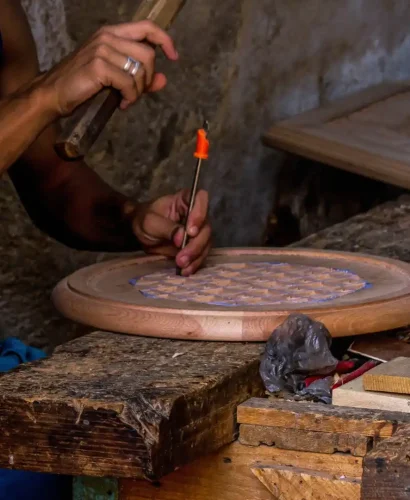 a Carpenter crafting traditional table in old medina Fez Morocco tours