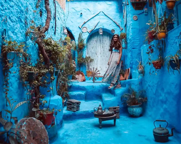 a girl in narrow alley in chefchaouen Morocco Sahara tours Day Trips-and Excursions