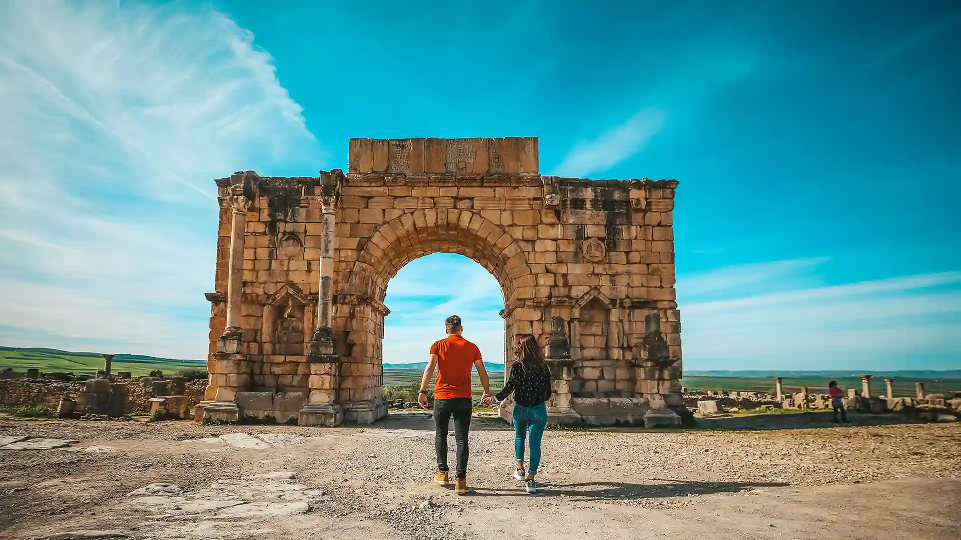 couple in Volubilis a Berber-Roman city in Morocco day trip